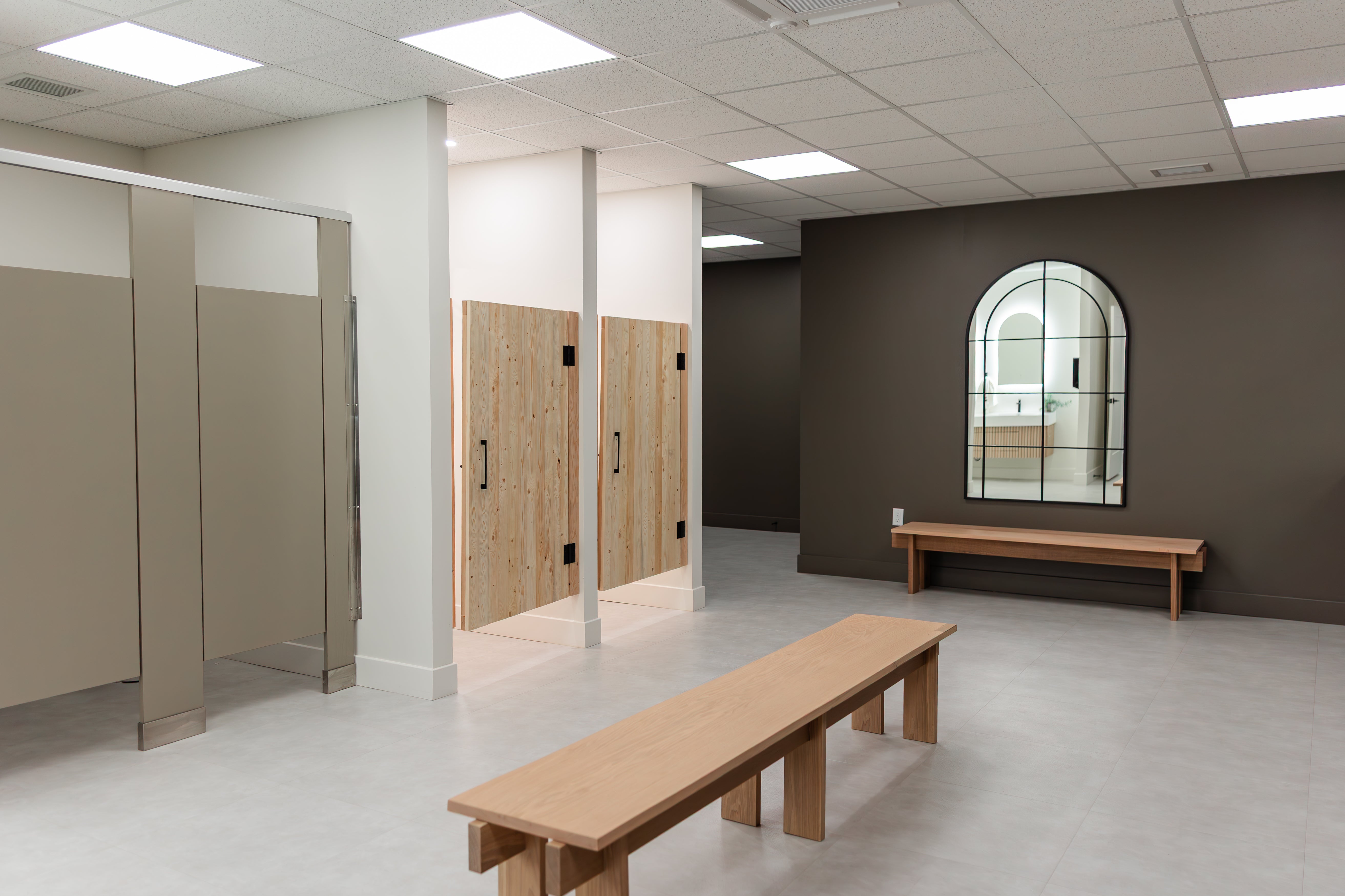 Prana Fredericton changing room with benches, showers, and mirror for post-class recovery