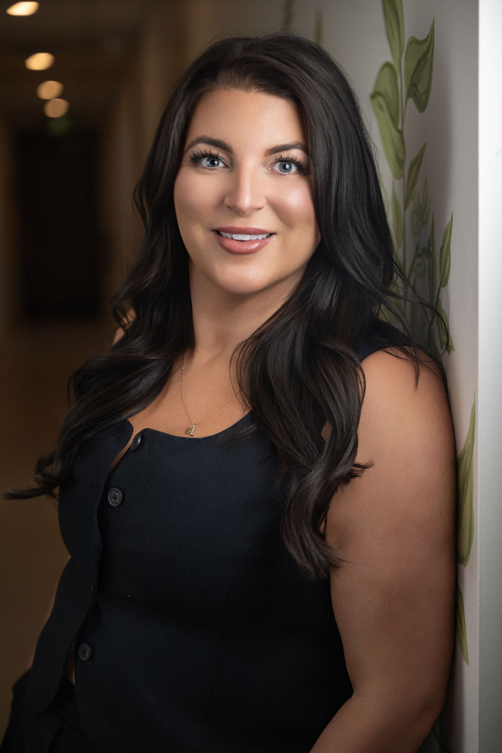 Leah Cain, founder of Prana Fredericton, smiling in the hallway